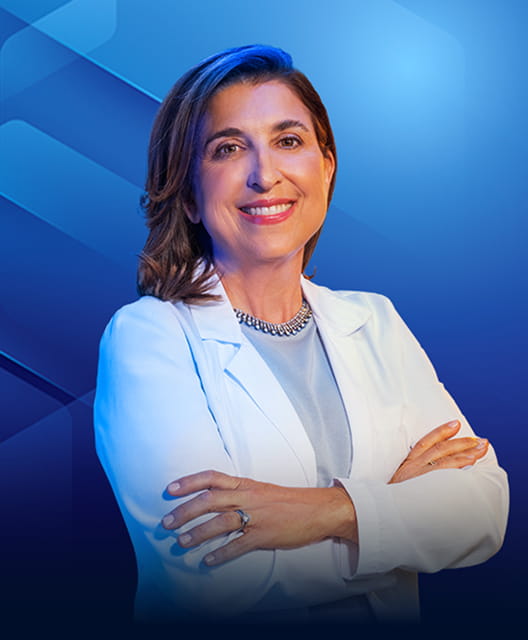 Dr Christine Molmenti, PhD, MPH, smiling with arms crossed in a white coat.